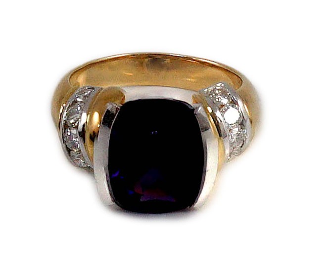 A modern 18ct gold and single stone cushion cut amethyst set dress ring, with ten stone diamond set shoulders